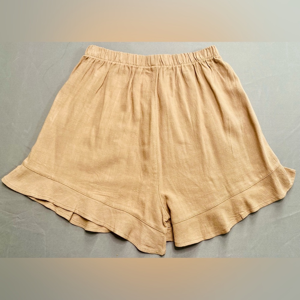 95% polyester and 5% spandex tan shorts.